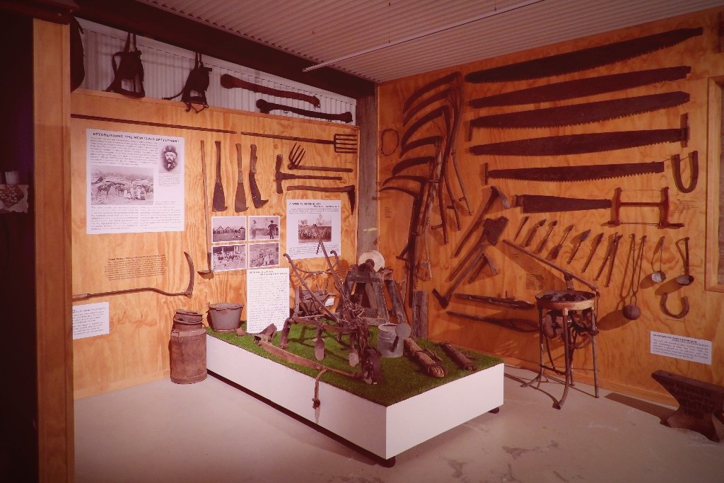 Antique blacksmith and farm tools on display