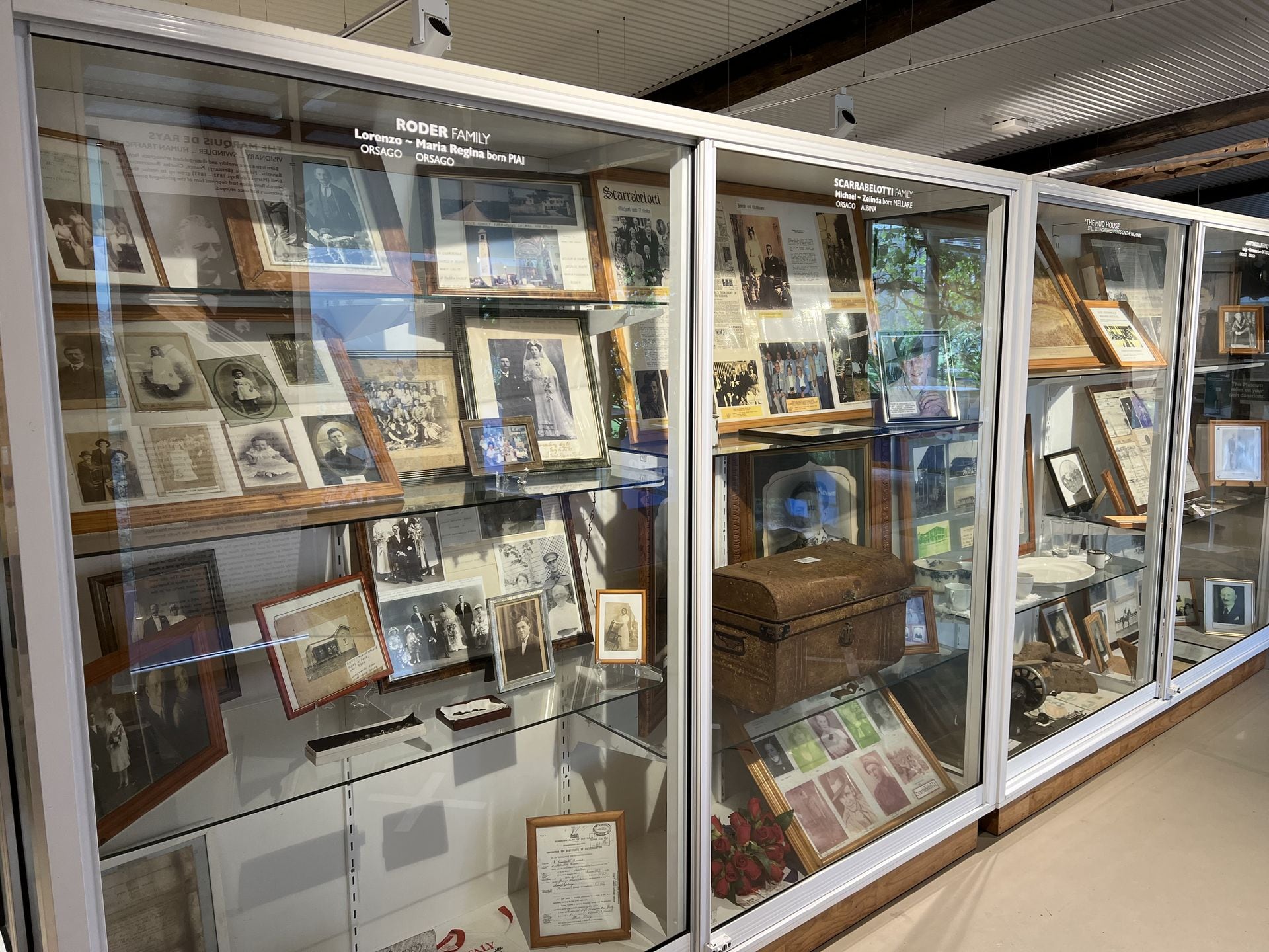 Visitors reading museum displays of settler photographs