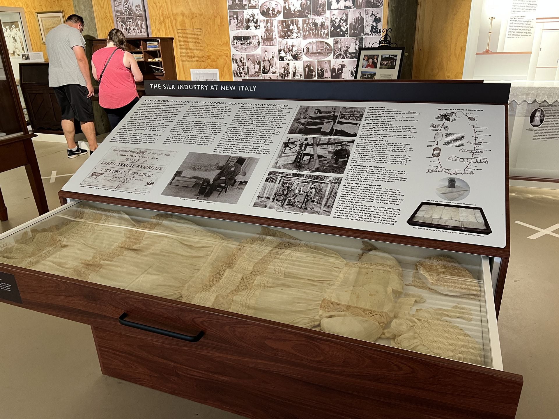 Silk Industry at New Italy exhibit, with garments and exhibition ribbons